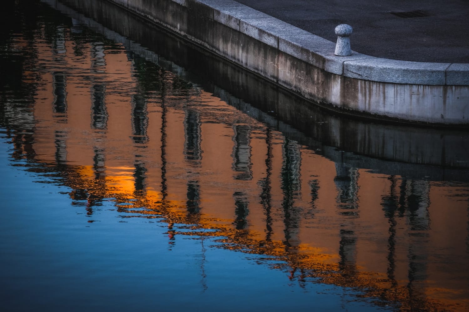 Waterfront infrastructure reflected in canal water representing urban flood resilience and climate adaptation strategies